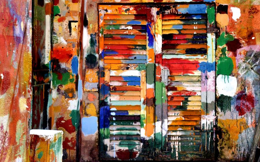 Colorful paint-splattered wall and shutters