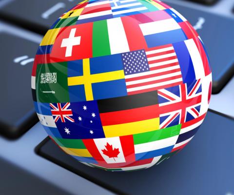 Globe of flags atop a keyboard